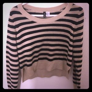 A loose black and beige striped sweater.